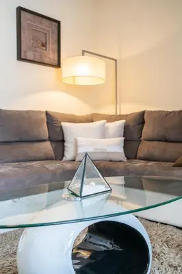 a glass coffee table in a living room with a couch at America Apartment by Holiday Rental Madeira in Funchal