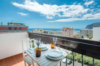 a shelf with two vases and two speakers on it at America Apartment by Holiday Rental Madeira in Funchal