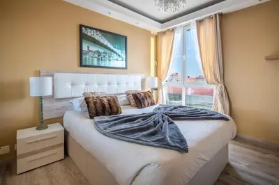 a bedroom with a large bed with a large window at America Apartment by Holiday Rental Madeira in Funchal