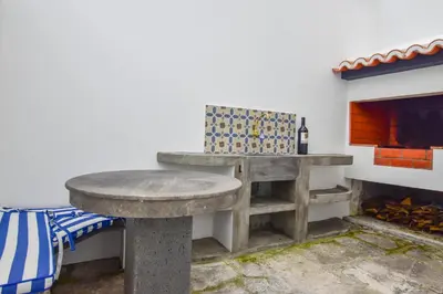 a stone bench in a room with a fireplace at A Casa da Graça Reis by Horizon View Madeira in São Vicente