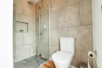 a bathroom with a toilet and a shower at A Casa da Graça Reis by Horizon View Madeira in São Vicente