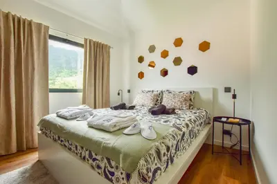 a bedroom with a bed with towels on it at A Casa da Graça Reis by Horizon View Madeira in São Vicente