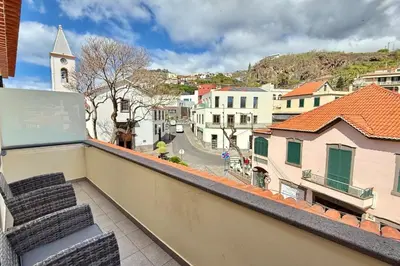 a balcony with a view of a city at Serena Bay in Câmara de Lobos