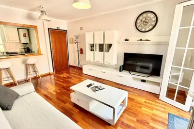 a living room with a couch and a tv at Serena Bay in Câmara de Lobos