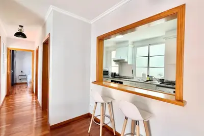 a kitchen with a mirror and two stools at Serena Bay in Câmara de Lobos