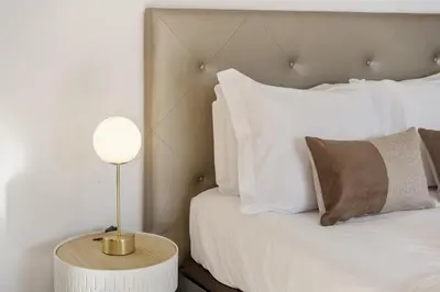 a bedroom with a bed and a table with a lamp at Forum Garden View 5A by Homie in Funchal