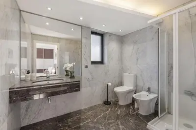 a bathroom with a toilet and a sink and a shower at Forum Garden View 5A by Homie in Funchal