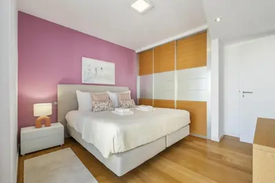 a bedroom with a white bed and a purple wall at Forum Ocean View 5C by Homie in Funchal