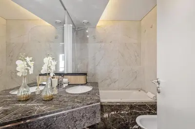 a bathroom with two sinks and a bath tub at Forum Ocean View 5C by Homie in Funchal