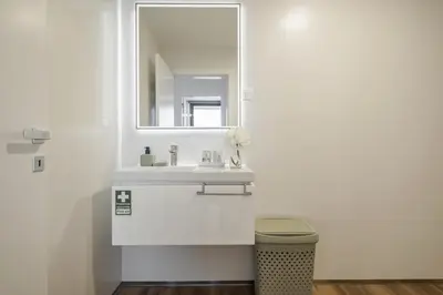 a white bathroom with a sink and a mirror at Atlantic Gem by Homie in Câmara de Lobos