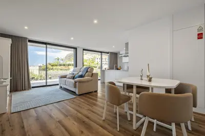 a kitchen and living room with a table and chairs at Atlantic Gem by Homie in Câmara de Lobos