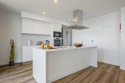 a kitchen with white cabinets and a white counter top at Atlantic Gem by Homie in Câmara de Lobos