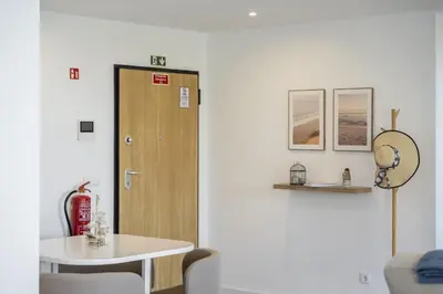 a room with a table and a wooden door at Atlantic Gem by Homie in Câmara de Lobos