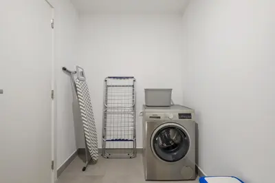 a washing machine and a cart in a room at Atlantic Gem by Homie in Câmara de Lobos