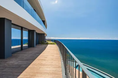 a view of the ocean from the balcony of a building at Atlantic Gem by Homie in Câmara de Lobos
