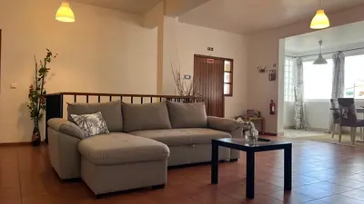 a living room with a couch and a table at ZainAli Guest House in Funchal