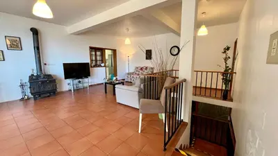 a living room with a couch and a television at ZainAli Guest House in Funchal