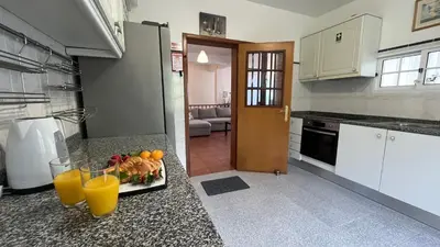 a kitchen with a plate of fruit and orange juice at ZainAli Guest House in Funchal