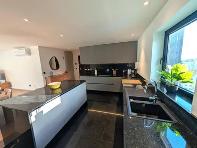 a kitchen with a sink and a counter top at Sky-High Elegance Top-Floor Views of City, Ocean & Sunrise in Funchal