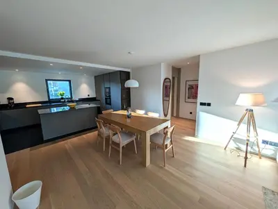 a dining room and kitchen with a table and chairs at Sky-High Elegance Top-Floor Views of City, Ocean & Sunrise in Funchal