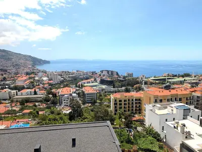 a view of a city from a building at Sky-High Elegance Top-Floor Views of City, Ocean & Sunrise in Funchal