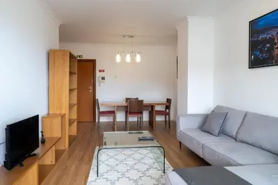 a living room with a couch and a table at Garajau Sea View in Caniço