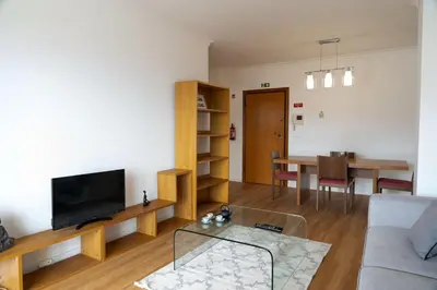 a living room with a couch and a table at Garajau Sea View in Caniço
