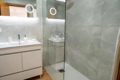 a bathroom with a shower and a sink at Garajau Sea View in Caniço