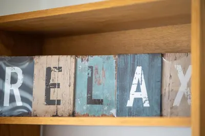 a group of books sitting on a shelf at Garajau Sea View in Caniço