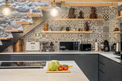 a kitchen with a counter with vegetables on a table at Villa Pomar, By OP in Senhora do Rosário