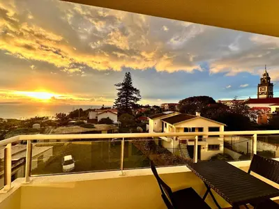 a view of a sunset from the balcony of a house at Prestige Solmar - Sea View Apartment - Free covered parking - Caniço Center in Caniço