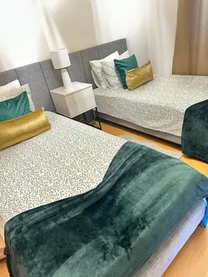 a living room with two beds and a couch at Prestige Solmar - Sea View Apartment - Free covered parking - Caniço Center in Caniço