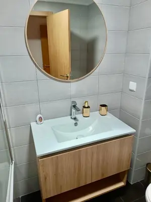 a bathroom with a sink and a mirror at Prestige Solmar - Sea View Apartment - Free covered parking - Caniço Center in Caniço