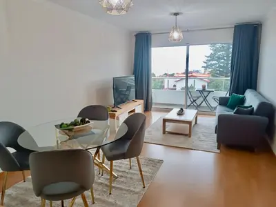 a living room with a glass table and chairs at Prestige Solmar - Sea View Apartment - Free covered parking - Caniço Center in Caniço