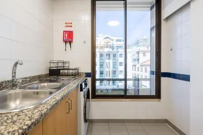 a bathroom with a sink and a window at Yellow Sun Studio - Cozy Stay in Central Funchal in Funchal