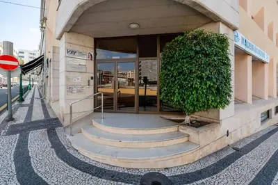 a building with a large bush outside of it at Yellow Sun Studio - Cozy Stay in Central Funchal in Funchal