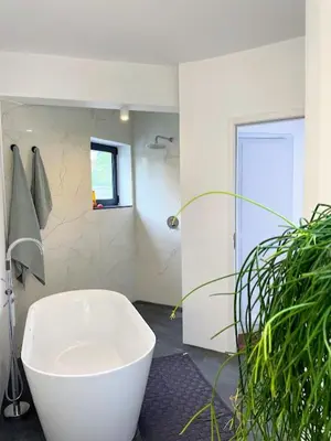 a white bath tub in a bathroom with a plant at TheView in Funchal