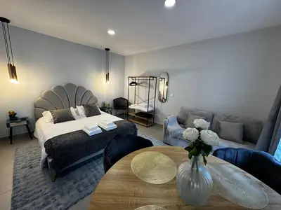 a bedroom with a bed and a table and a couch at São Pedro Paradise B Down in Funchal