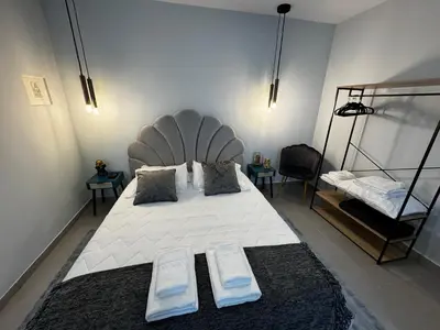 a bedroom with a large white bed with two pillows at São Pedro Paradise B Down in Funchal