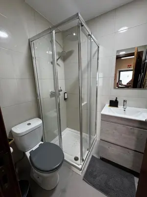a bathroom with a shower and a toilet and a sink at São Pedro Paradise B Down in Funchal
