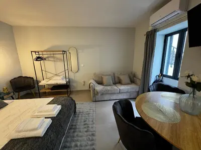 a living room with a table and a couch at São Pedro Paradise B Down in Funchal