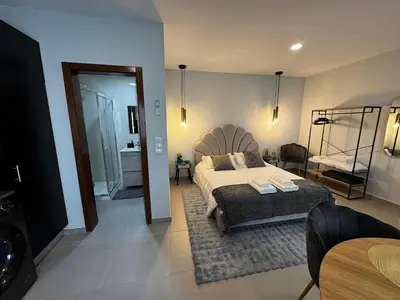 a bedroom with a large bed and a bathroom at São Pedro Paradise B Down in Funchal