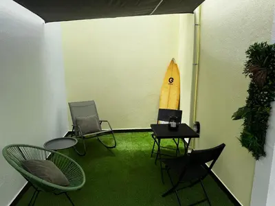 a room with chairs and a surfboard on the wall at São Pedro Paradise B Down in Funchal