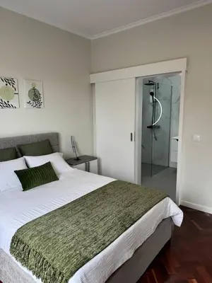 a bedroom with two beds and a large mirror at Achada de Gaula House in Gaula