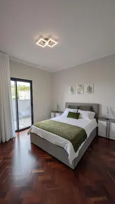 a bedroom with a large bed and a wooden floor at Achada de Gaula House in Gaula