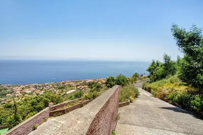 a road leading down a hill to the ocean at Studio Casa Belavista in Gaula