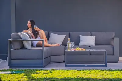 a woman sitting on a couch with a glass of wine at Villa Wiktoria, by Pausa Holiday Rentals in Ribeira Brava