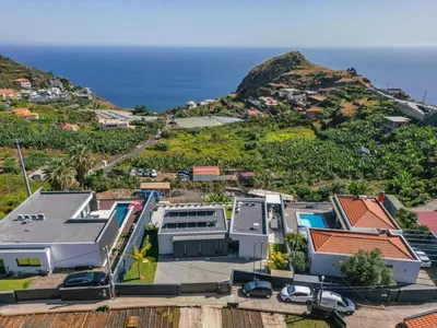 an aerial view of a house with the ocean in the background at Villa Wiktoria, by Pausa Holiday Rentals in Ribeira Brava