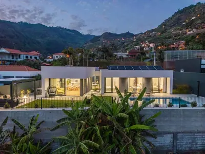 a house with solar panels on top of it at Villa Wiktoria, by Pausa Holiday Rentals in Ribeira Brava
