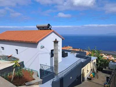 a white building with a clock tower on top of it at House Virginia in Santa Cruz